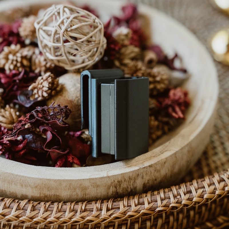 The belt clip in a bowl of dried flowers