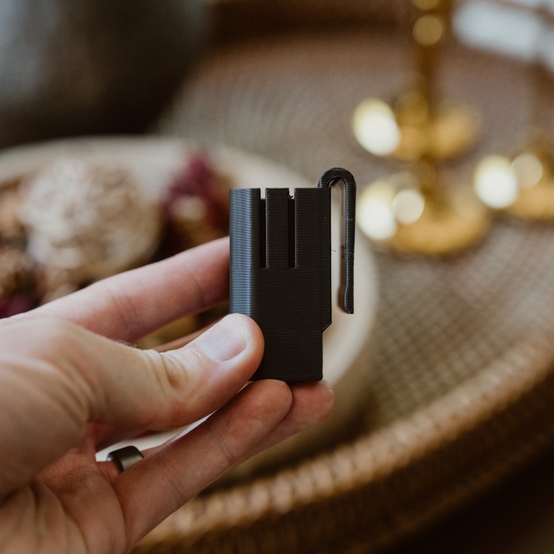 The empty clip in hand, showing the clip arm