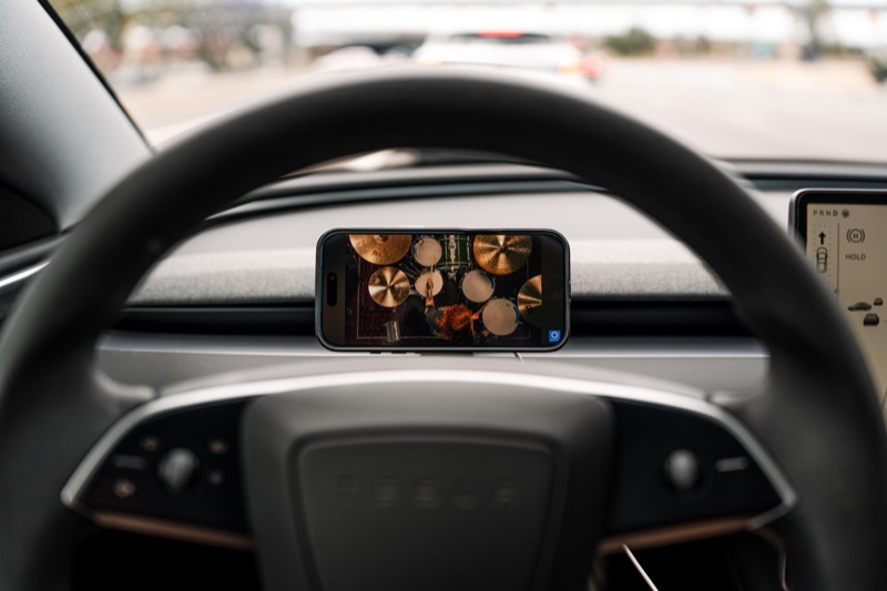 Phone on the mount playing video, parked